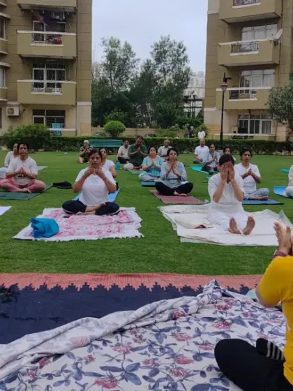 Leading the community in prayer and intention setting during our outdoor yoga event in Indirapuram. We start our practice by centering ourselves.