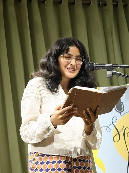 A poet reading from her journal, sharing personal and powerful words.