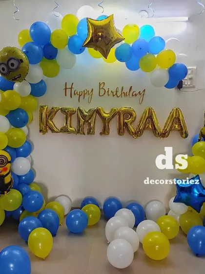 A close-up of the Minion-themed balloon arch, perfect for a home party celebration.