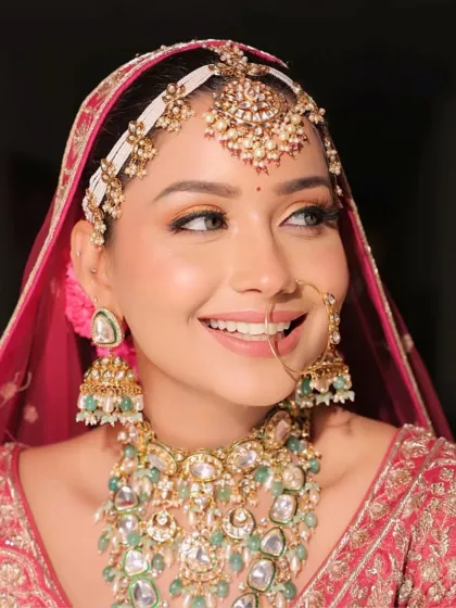 The smile says it all. This close-up captures the bride's joy and the beautiful details of her makeup, including the peach shimmer on her eyes and her radiant skin.