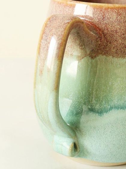 A detailed look at the handle and the smooth, glossy finish of the Pist-a-chio mug. I pay close attention to the ergonomics to ensure every sip is a comfortable experience.