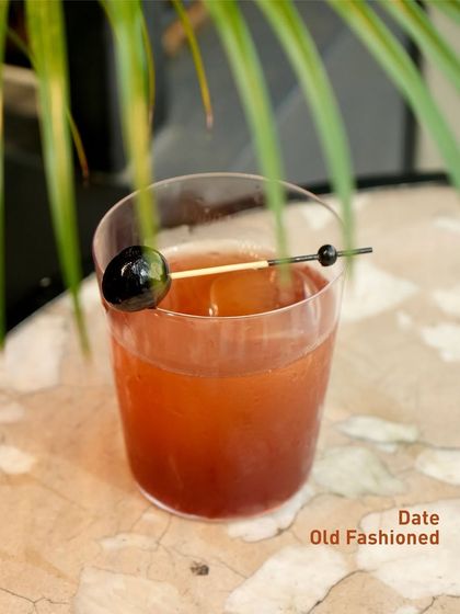 The Date Old Fashioned, a sweet and rich twist on the classic. The natural sweetness of dates adds a new layer of complexity to this timeless cocktail.