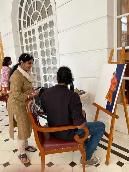 An organizer from ArtMantram checking in on my progress during the live painting event.