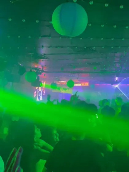 The view from my console on a Saturday night. The green laser cuts through the crowd, and everyone is lost in the music.