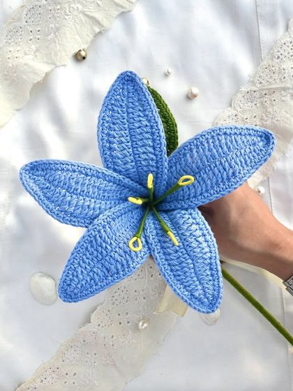 This stunning single blue crochet lily makes a bold and beautiful statement. The vibrant color and intricate stitching are truly eye-catching.