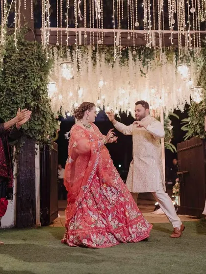 The groom hyping up his bride as they make their grand entrance. It's these candid, joyful moments that we love to create.