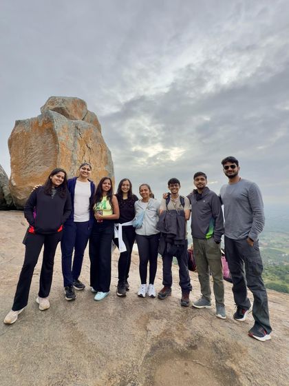 Posing by a unique rock formation, this group of trekkers smiles for a picture. The landscapes are the backdrop, but the friendships formed are the main event.