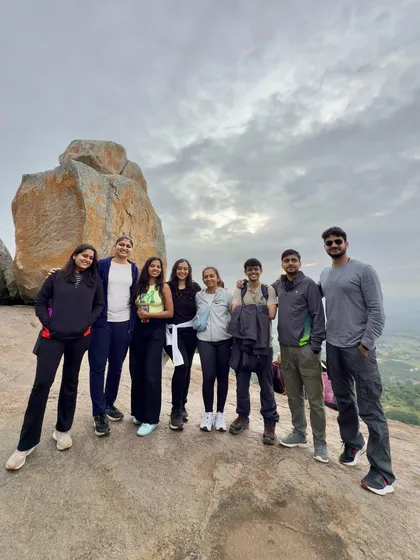 Posing by a unique rock formation, this group of trekkers smiles for a picture. The landscapes are the backdrop, but the friendships formed are the main event.