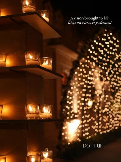 A close-up of the elegant lighting details from a royal-themed wedding in Jodhpur. The warm glow of candles in glass votives is complemented by the soft, out-of-focus sparkle of fairy lights in the background.