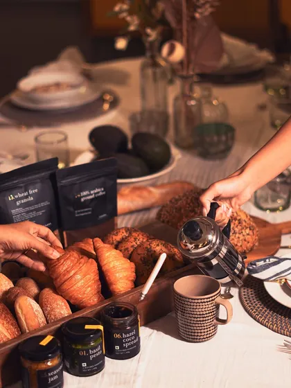 We believe breakfast should be an occasion. Here is a beautiful morning spread featuring our freshly baked croissants and breads, served alongside our artisanal hazelnut coco spread, seasonal jam, and freshly brewed Arabica Mysore bean coffee.