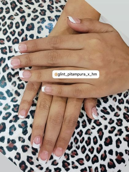 Another example of our classic French manicure service. We focus on creating the perfect "smile line" for the white tips, ensuring a clean and elegant look on these natural-length nails.