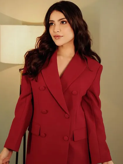 A confident and powerful pose, perfect for an editorial spread. The makeup is subtle yet effective.