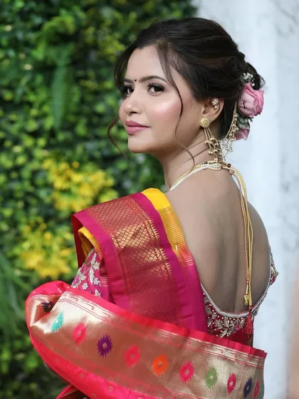 Another angle of Siddhi's beautiful bridal hairstyle. The neat bun and traditional jewelry are a perfect match for her Paithani saree.