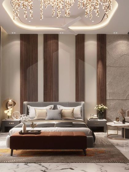 We used a combination of vertical wood and stone-textured panels to create a visually interesting feature wall in this luxury bedroom. The design is complemented by a beautiful chandelier and a cozy seating area, resulting in a warm and modern retreat.