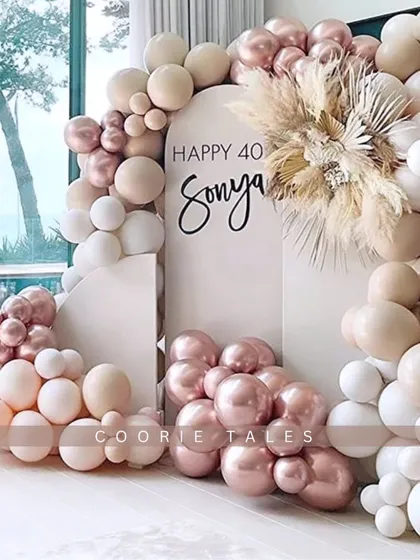 Marking a milestone 40th birthday with style and sophistication. This chic setup uses a trendy palette of rose gold, beige, and white balloons, with dried pampas grass for a modern boho touch.