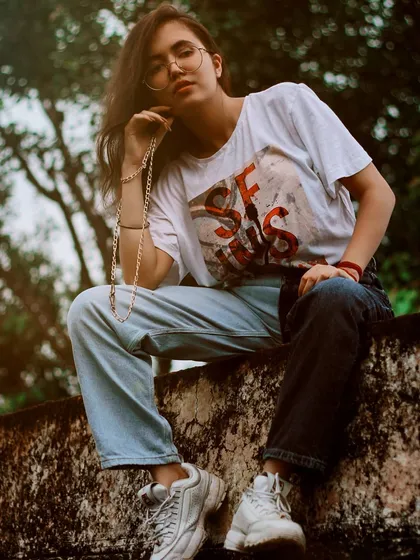 For this lifestyle fashion shoot in Bharatpur, we used the texture of a rustic wall as our backdrop. The model is posed naturally, sitting on the wall, which creates an authentic and relaxed feel, showcasing how personal style can blend with heritage locations.
