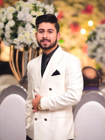 A close up of the client in the white double breasted blazer. The focus is on a sharp, clean look that is both modern and timeless.