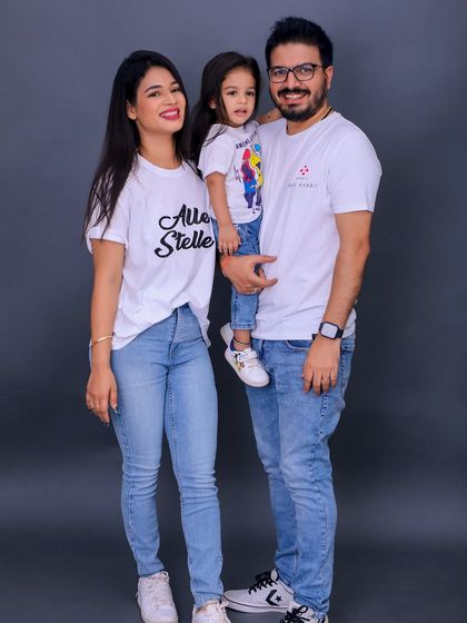 A relaxed and modern family portrait in matching casual outfits. Our studio is versatile enough to capture any style, from formal to this fun and laid back jeans and t-shirt look.