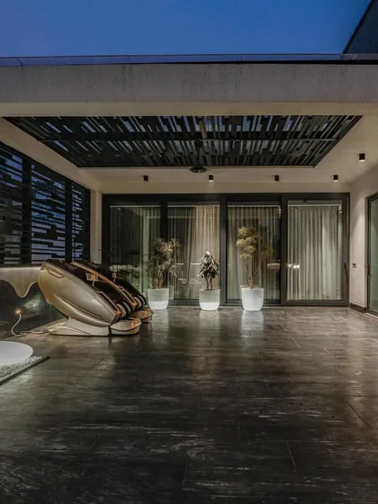 Another zone of the Vikaspuri terrace, this one featuring a slatted pergola roof and seamless access to the interior spaces.