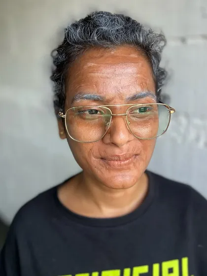 Another angle of the old-age character makeup, demonstrating the student's skill in transforming a person's appearance through makeup.