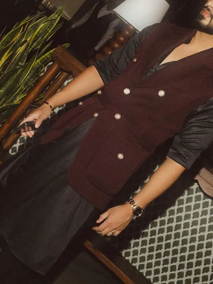 A candid shot capturing the movement and fit of the draped kurta and waistcoat combination.