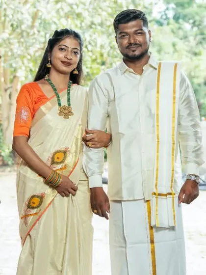 A classic portrait of a couple in traditional South Indian outfits, framed by an elegant doorway for their pre-wedding album.