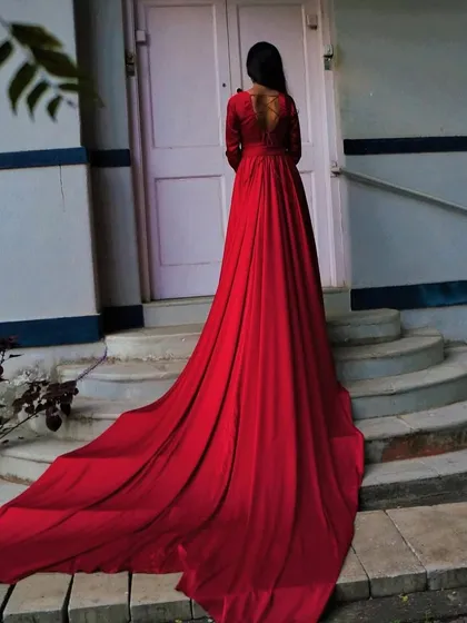 The back view of our liquid silk gown in siren red. The extra-long trail flows beautifully, creating a dramatic silhouette that is perfect for photoshoots.