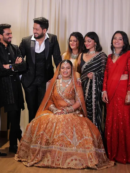 A happy group photo with the bride and other wedding guests. It's always fun to see how everyone styles their outfits for a big Indian wedding.