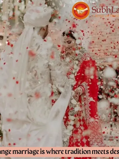 A couple stands together during their wedding ceremony, showered in red petals. This image captures how tradition and destiny meet in a beautiful arranged marriage.