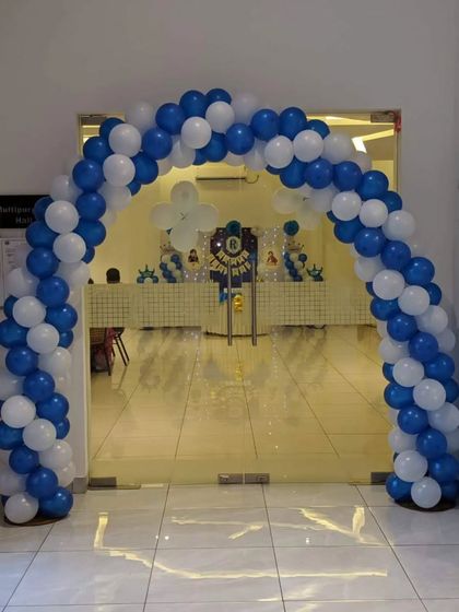 A classic blue and white balloon arch for a party entrance.