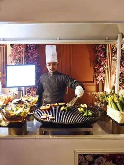 A live grill station where our chef prepares freshly grilled vegetables, offering a healthy and delicious option for guests.