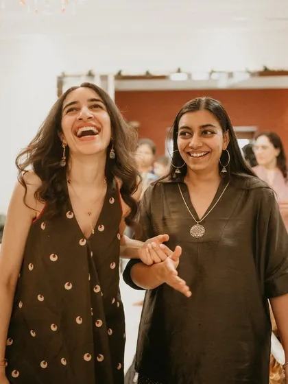 A candid moment of laughter between us. Our work is built on our friendship and shared vision. We believe that the best styling comes from a place of genuine connection and understanding.