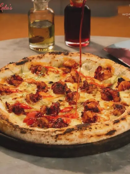 A drizzle of chili oil adds the perfect finishing touch to this spicy chicken pizza. It’s all about building layers of flavor.