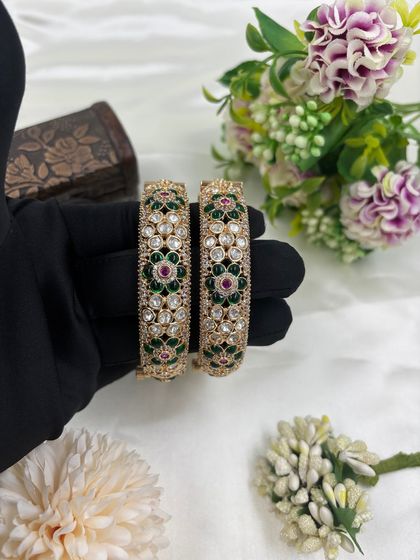 A pair of stunning openable bangles with multi-color floral Meenakari work. The combination of green, red, and white stones makes these bangles a versatile accessory.