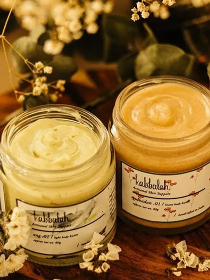 Here are two of my favorite body butters, the light 'Ang' and the heavy 'Gulbadan'. Each is whipped to a perfect consistency to deeply nourish your skin, showing the variety of textures I create for different skin needs.