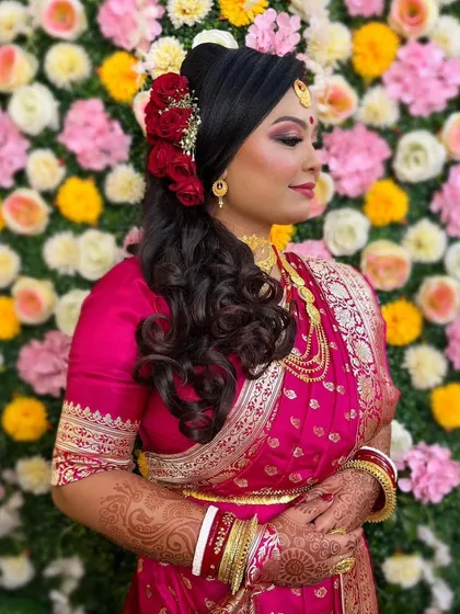 Another beautiful shot of the bride's reception look, highlighting the intricate hairstyle with rose details and the perfectly applied makeup that will last all night.