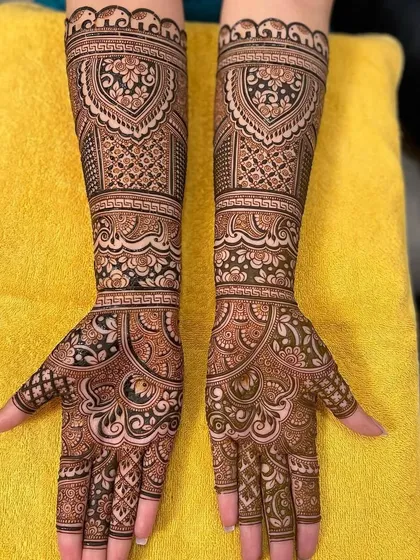 A very full and intricate design, with dense patterns covering the entire hands and forearms.
