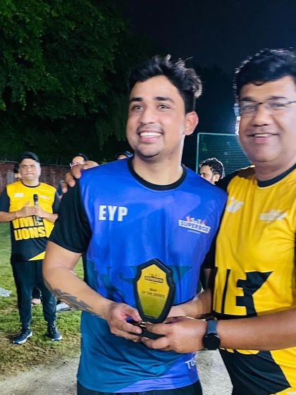 A player proudly receives his award during the presentation ceremony. These accolades recognize the standout performers in every tournament.