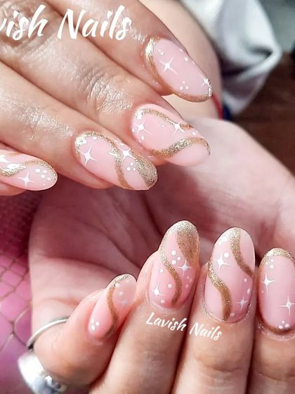 A whimsical design with a pink base, gold glitter swirls, and tiny white star and dot details.