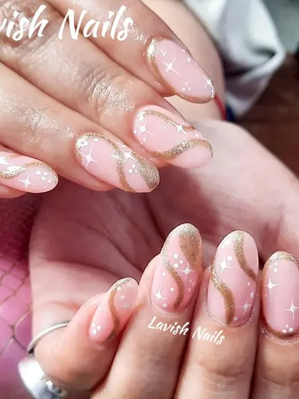 A whimsical design with a pink base, gold glitter swirls, and tiny white star and dot details.