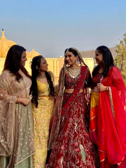The bride with her bridesmaids at a palace wedding. We coordinate with the entire bridal party to create picture-perfect moments.