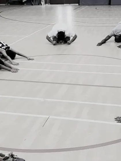 A cool-down session is just as important as the main workout. Here, our players are performing deep stretches in a circle, helping with muscle recovery and promoting mindfulness after an intense training session.