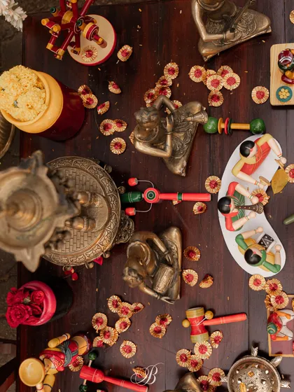 I believe in celebrating local artistry. This tablescape is a vibrant collection of hand-painted Channapatna toys, intricate brass artifacts, and colorful floral petals, creating a rich tapestry of texture and tradition that tells a uniquely Indian story.