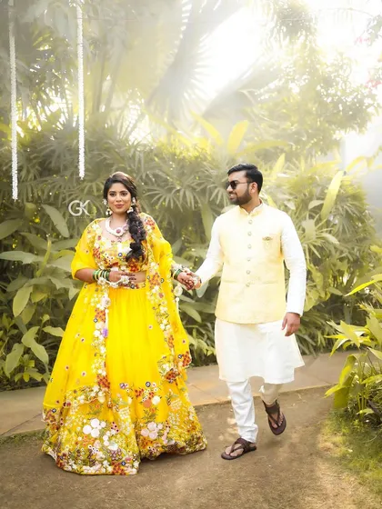 A bride in a stunning yellow embroidered lehenga, her look enhanced by our custom floral set.