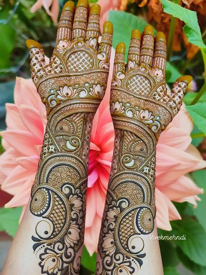 A gorgeous full-hand design with swirling peacock and floral patterns. The shading and fine lines create a beautiful 3D effect.