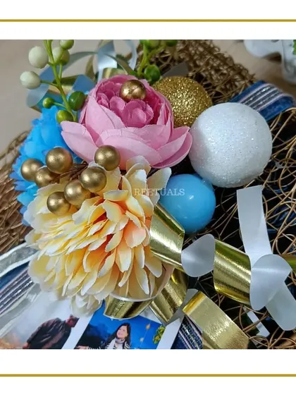 A close-up of the floral decor, showing the mix of blue, pink, and cream flowers with gold accents, used to adorn our hampers.