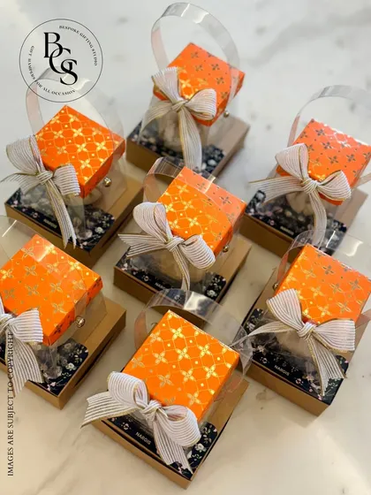 For Ganesh Chaturthi, I designed these lovely return gifts. The bright orange boxes tied with elegant ribbons are a small but heartfelt token of appreciation for guests who join in your festive prayers and celebrations.