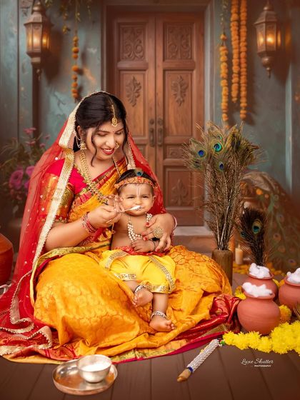 A sweet moment where "Yashoda" feeds her little Krishna. The detailed set and traditional attire make this a heartwarming and culturally rich photograph.