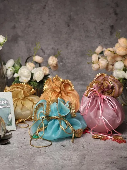 Colorful organza potlis are a fantastic, budget-friendly option for festive giveaways or as part of a larger hamper.
