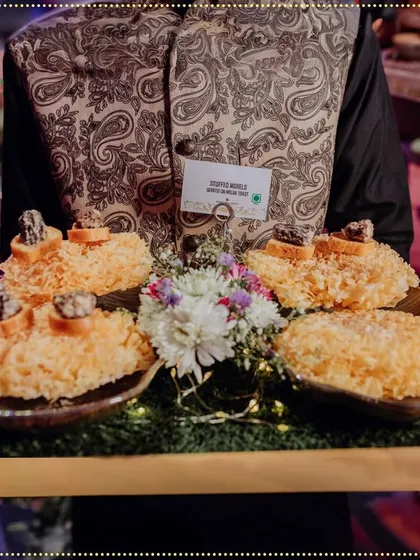 Our servers present unique creations like these Stuffed Morels on a bed of crispy noodles. Each dish is a celebration of love and flavor, crafted for an unforgettable experience.